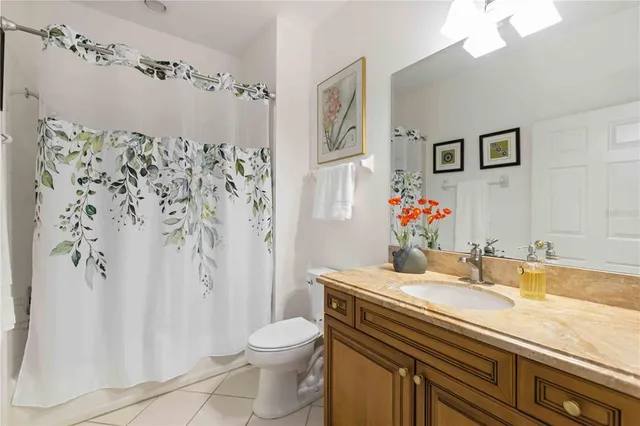 a view of swimming pool with seating area and trees in the background