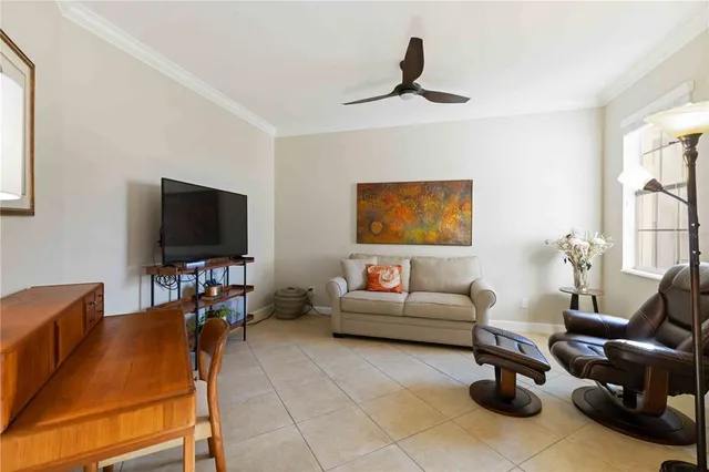 a room with lots of tables a large window and chairs