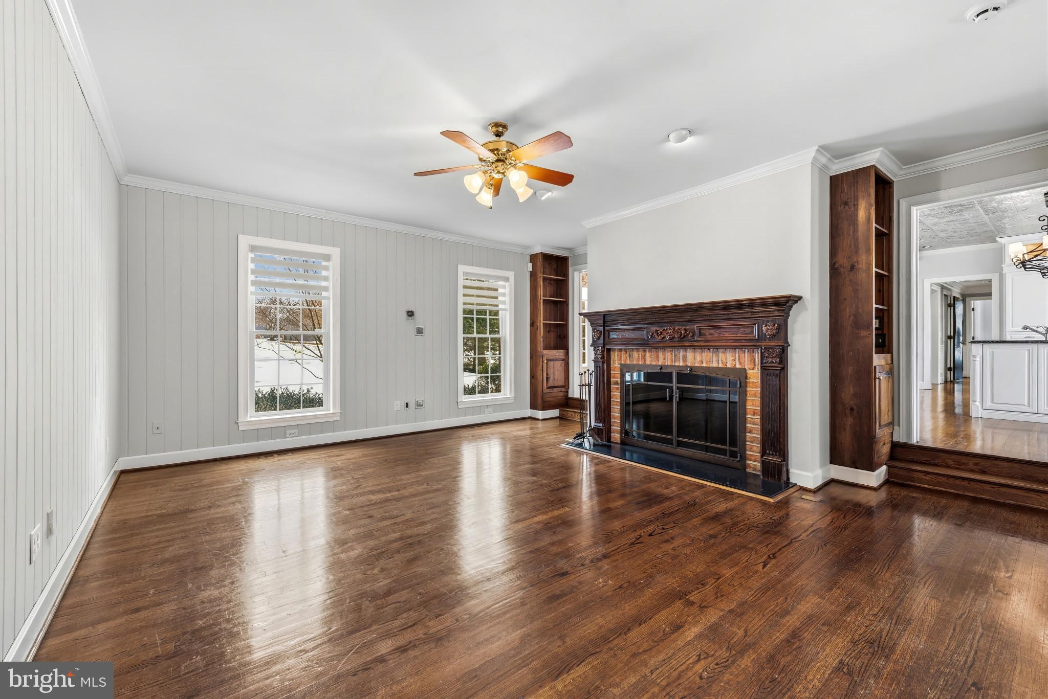 14002 Fox Run Court Phoenix, MD 21131 - Photo 13 of 64 an empty room with wooden floor fireplace and windows