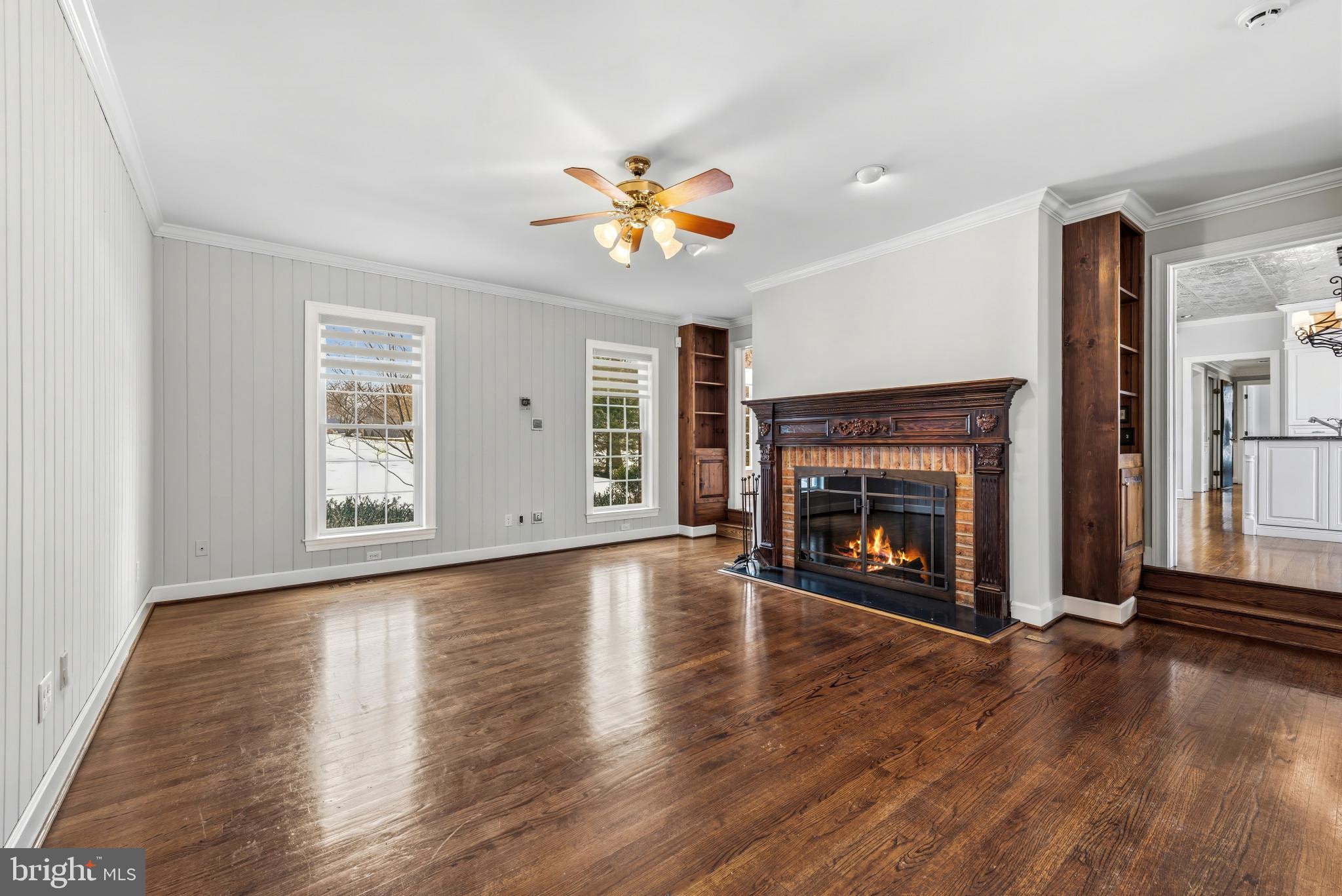 14002 Fox Run Court Phoenix, MD 21131 - Photo 14 of 64 an empty room with windows fireplace and wooden floor
