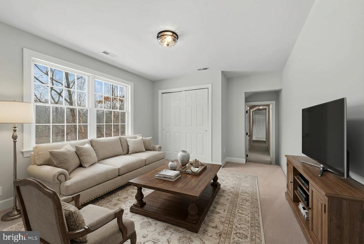 14002 Fox Run Court Phoenix, MD 21131 - Photo 33 of 64 a living room with furniture a flat screen tv and a window