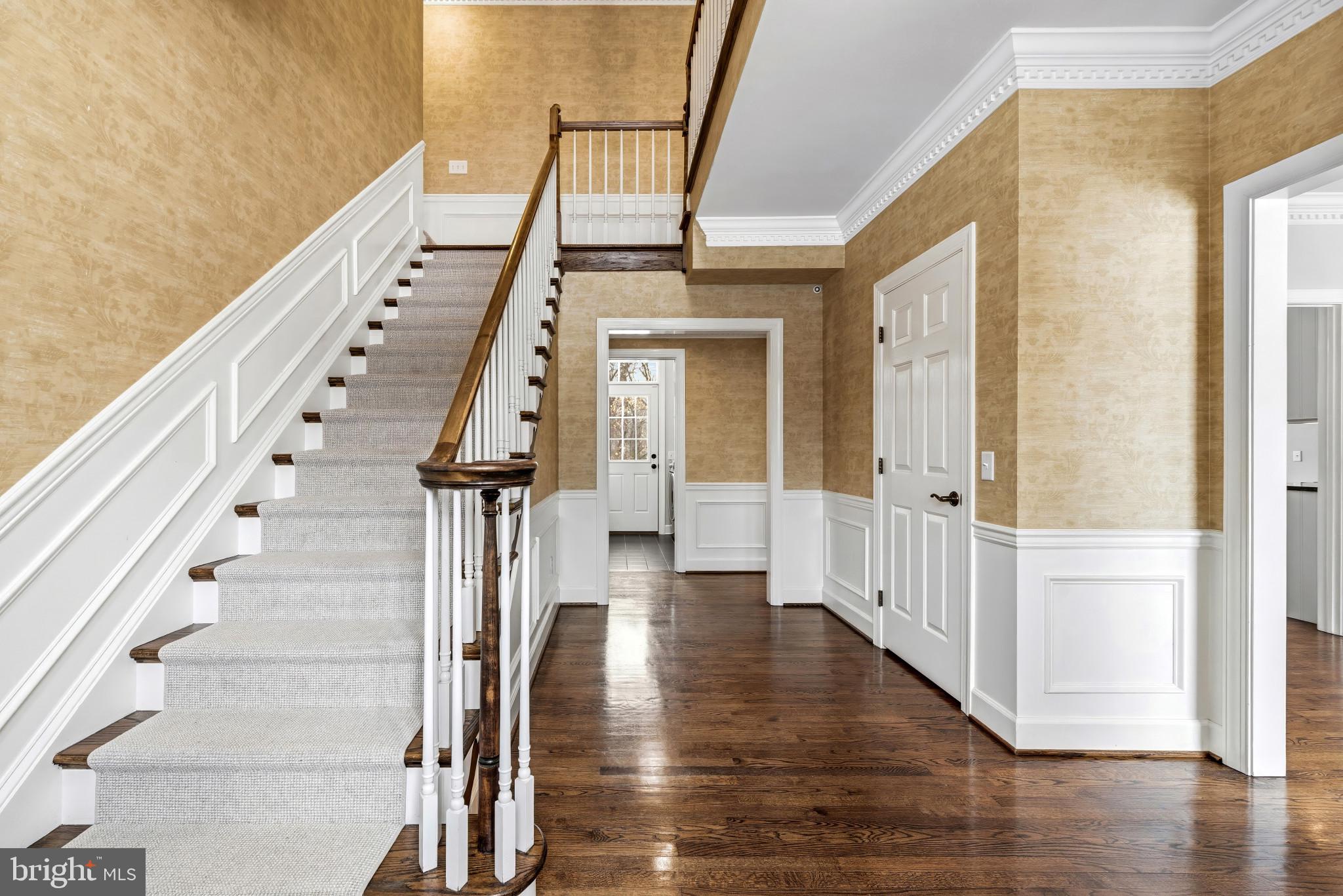 14002 Fox Run Court Phoenix, MD 21131 - Photo 6 of 64 a view of staircase with white walls and wooden floor