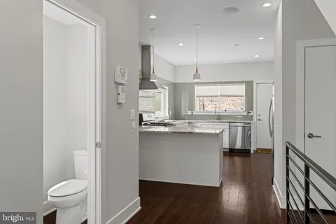 a kitchen with kitchen island a sink appliances and cabinets