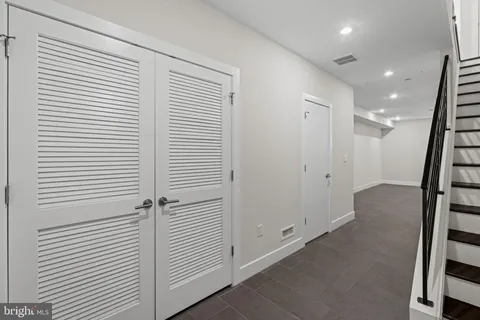 a view of a hallway with closet and stairs