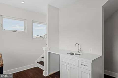 a bathroom with a sink a vanity and a mirror