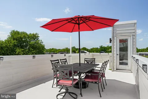 a view of an outdoor sitting area with furniture and umbrella