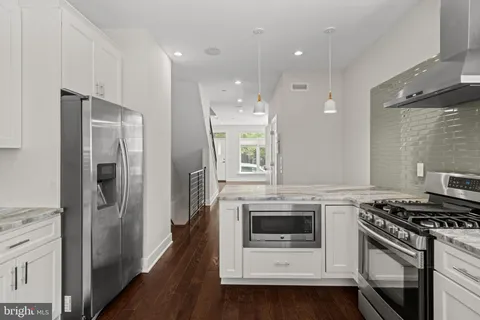 a kitchen with cabinets and stainless steel appliances