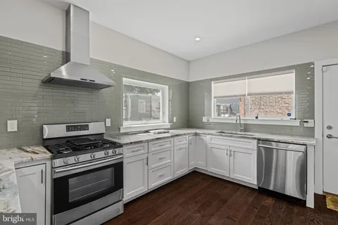 a kitchen with stainless steel appliances a stove sink and cabinets