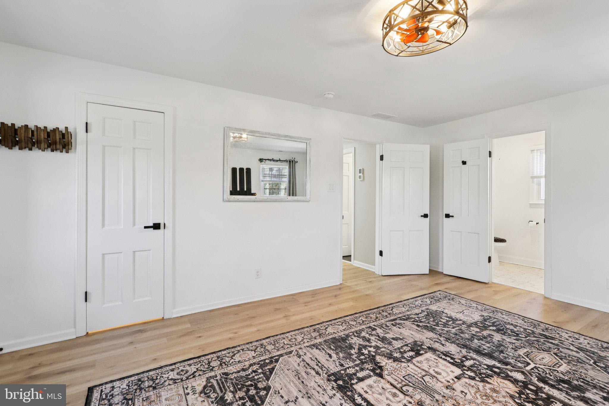 351 Merrick Road Robbinsville, NJ 08691 - Photo 34 of 69 a view of a room with wooden floor and a ceiling fan