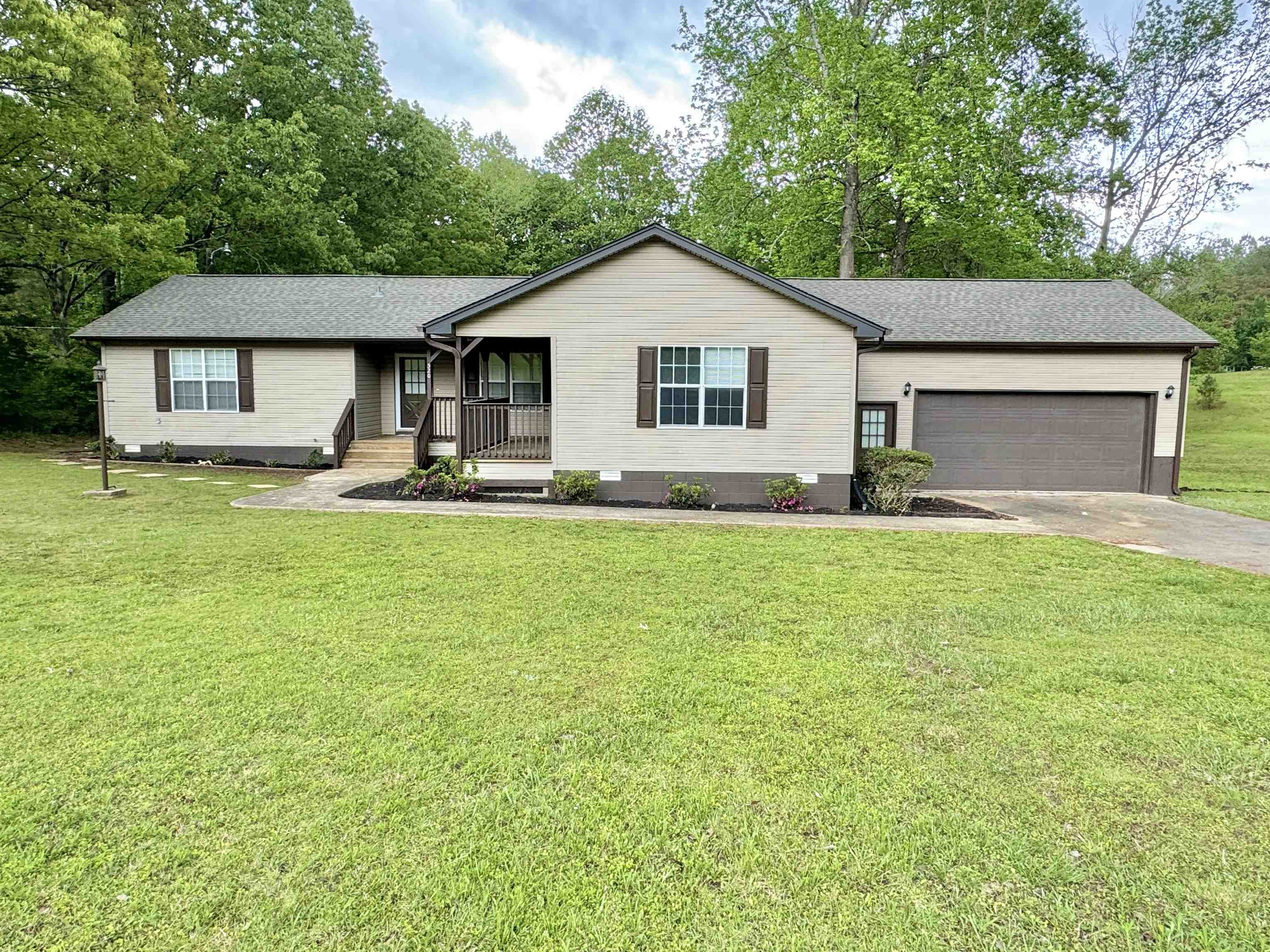 520 Stone Road Pinson, TN 38366 - Photo 1 of 30 Ranch-style house featuring a porch, a front lawn, crawl space, a garage, and concrete driveway