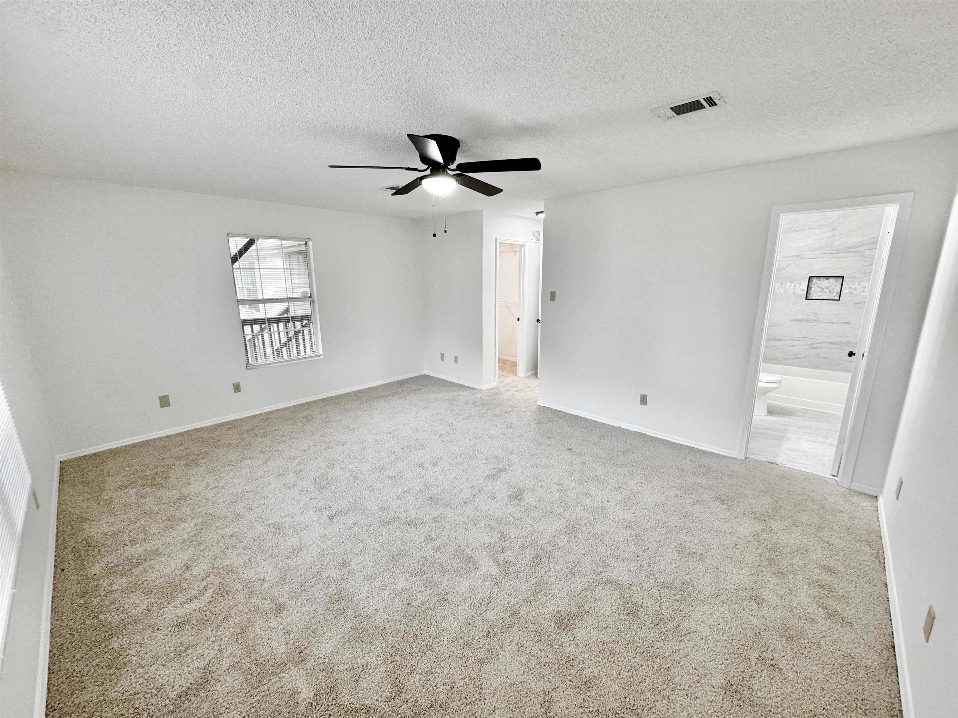 520 Stone Road Pinson, TN 38366 - Photo 11 of 30 Carpeted spare room with a textured ceiling, visible vents, ceiling fan, and baseboards