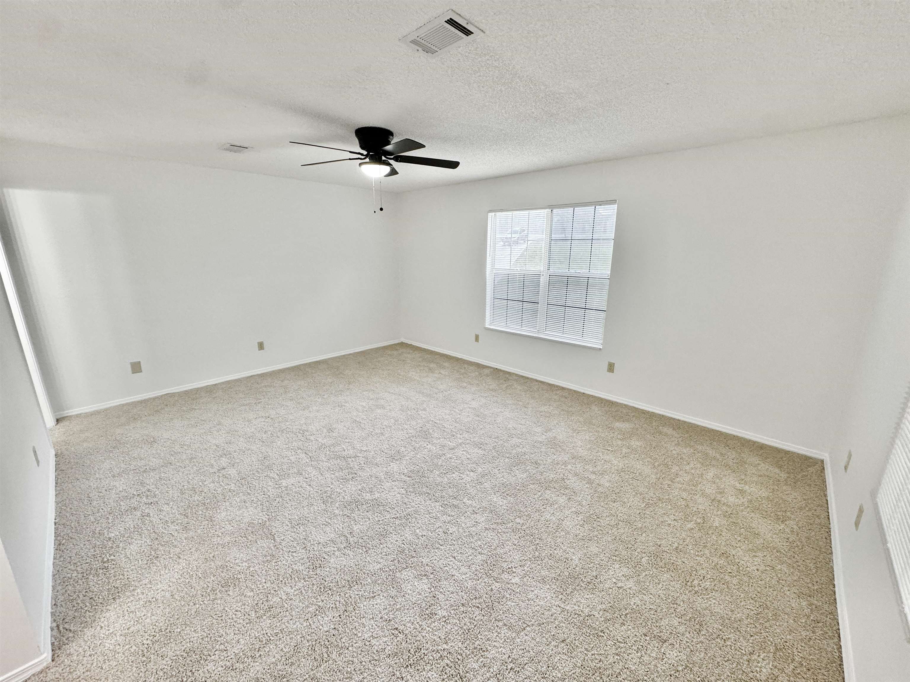 520 Stone Road Pinson, TN 38366 - Photo 13 of 30 Spare room with a textured ceiling, visible vents, baseboards, carpet floors, and a ceiling fan