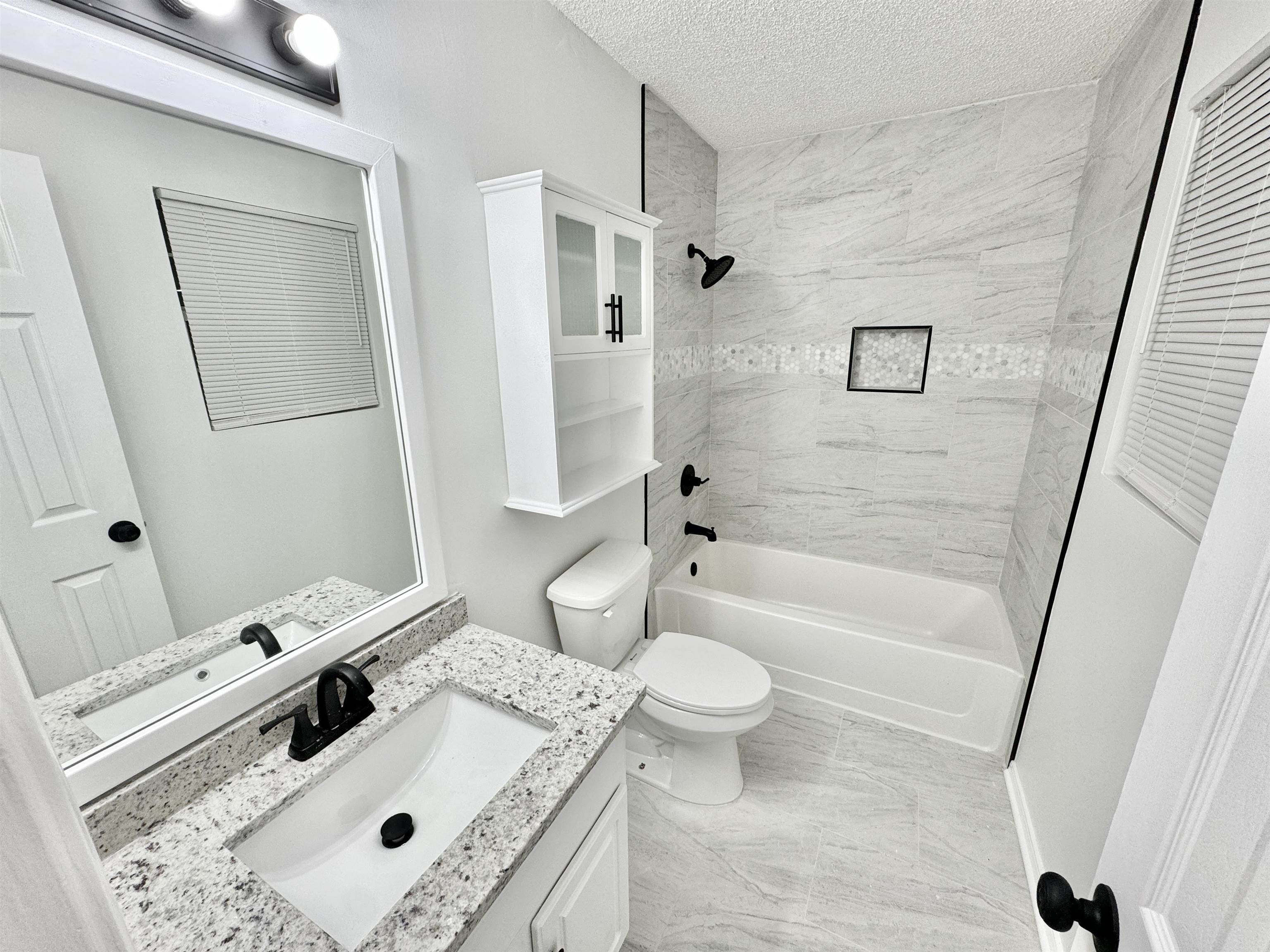 520 Stone Road Pinson, TN 38366 - Photo 15 of 30 Bathroom featuring toilet, a textured ceiling, bathing tub / shower combination, and vanity