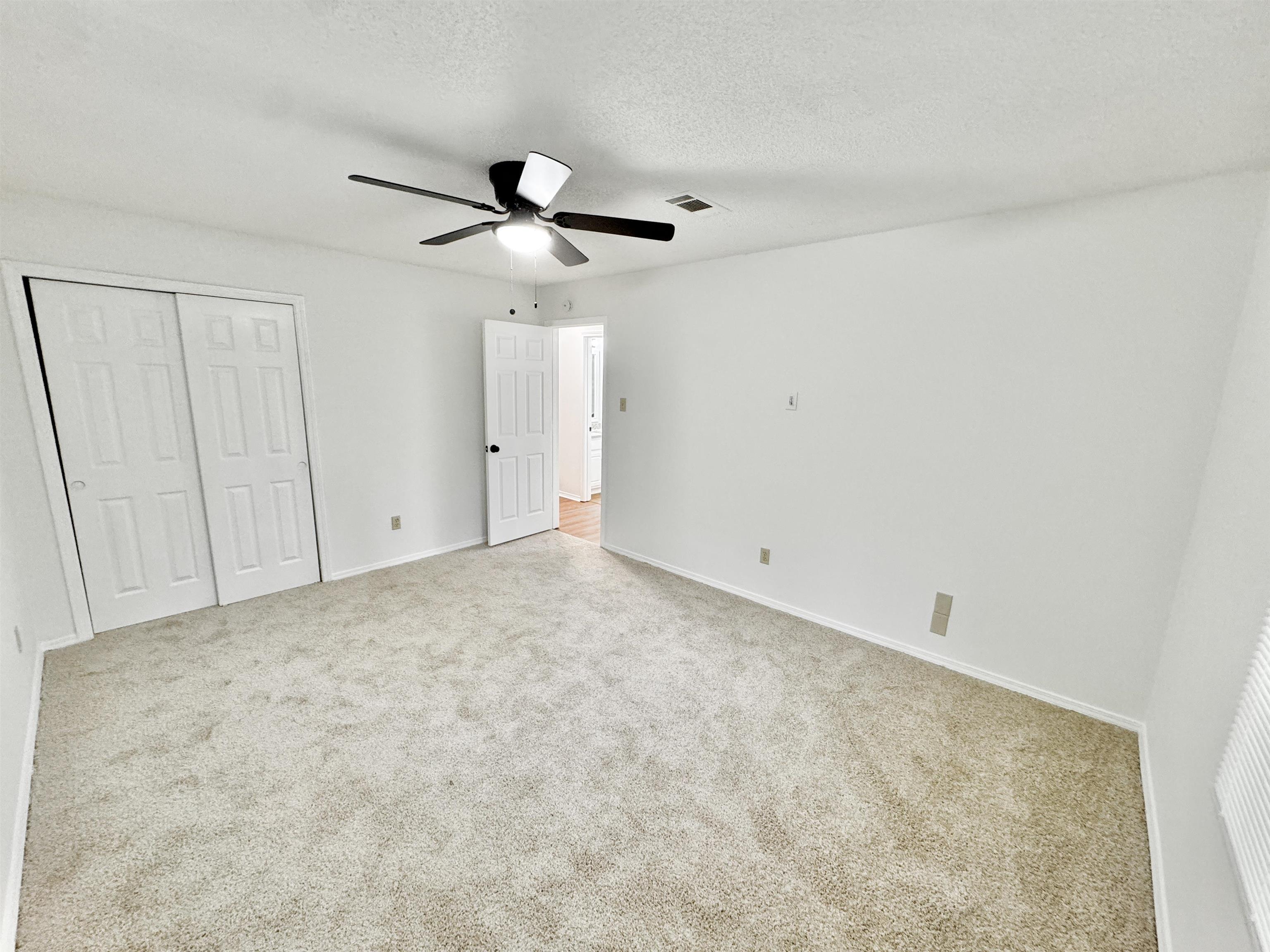 520 Stone Road Pinson, TN 38366 - Photo 18 of 30 Unfurnished bedroom featuring carpet flooring, a closet, a ceiling fan, visible vents, and baseboards