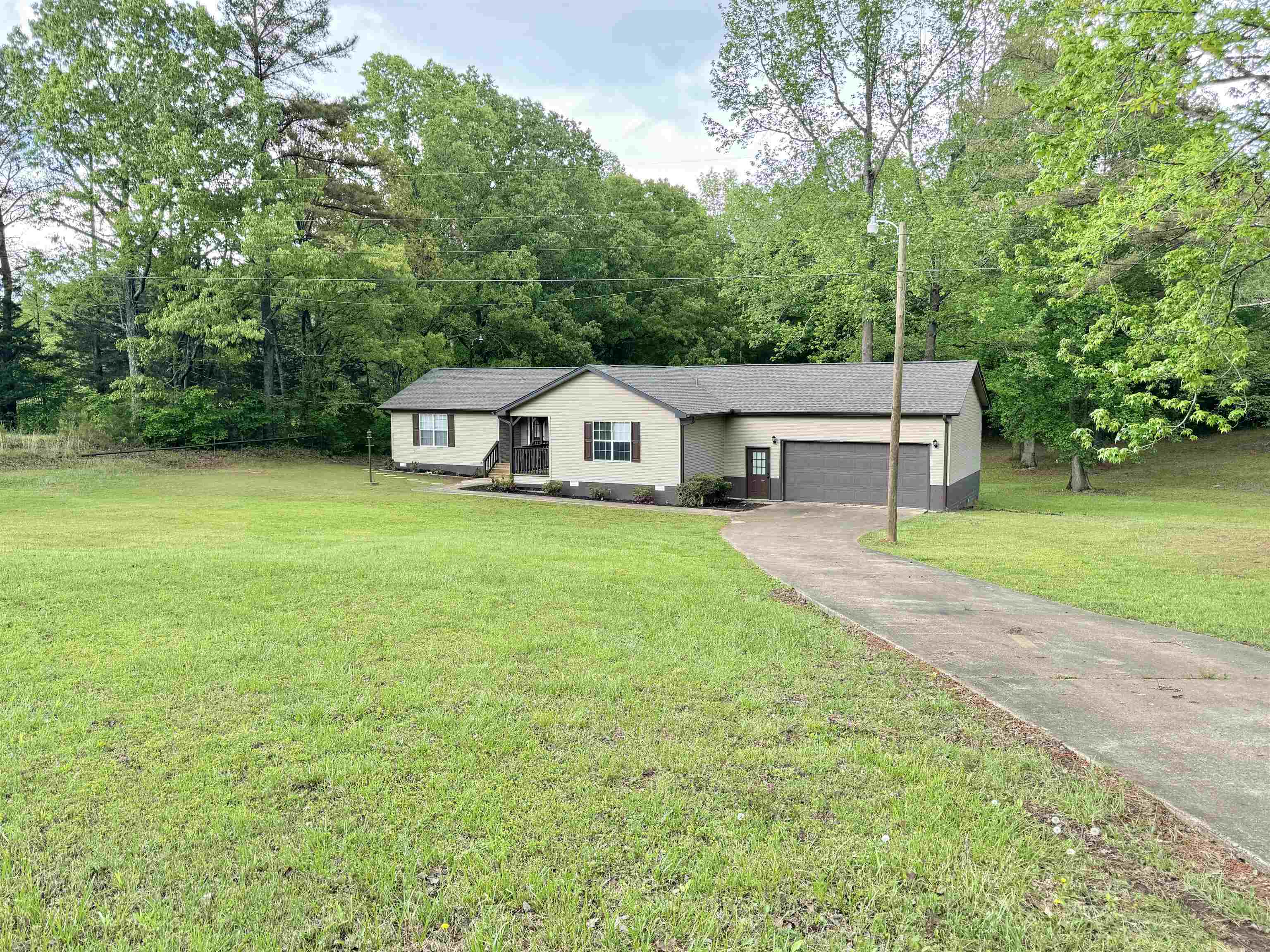 520 Stone Road Pinson, TN 38366 - Photo 2 of 30 Single story home with a front lawn, a garage, and aphalt driveway