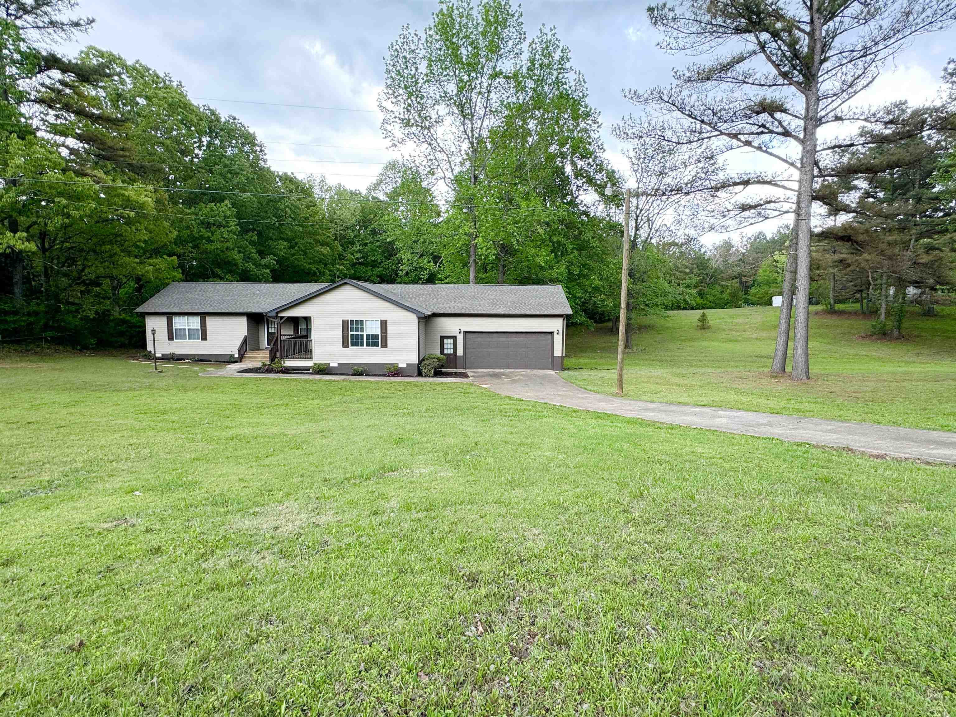 520 Stone Road Pinson, TN 38366 - Photo 26 of 30 View of front of house featuring a front lawn, driveway, and an attached garage