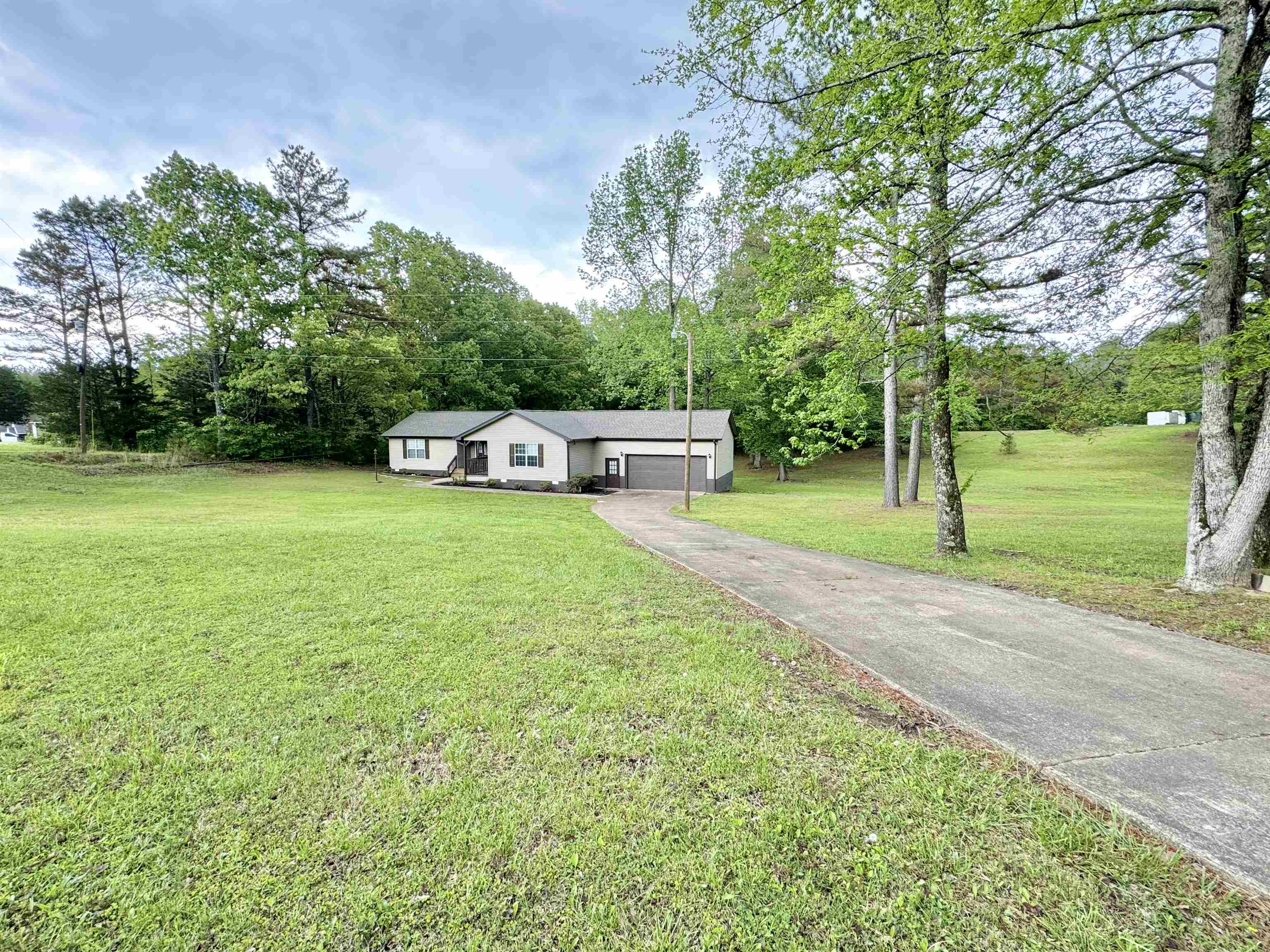 520 Stone Road Pinson, TN 38366 - Photo 29 of 30 View of front of home featuring a front lawn, driveway, and a carport