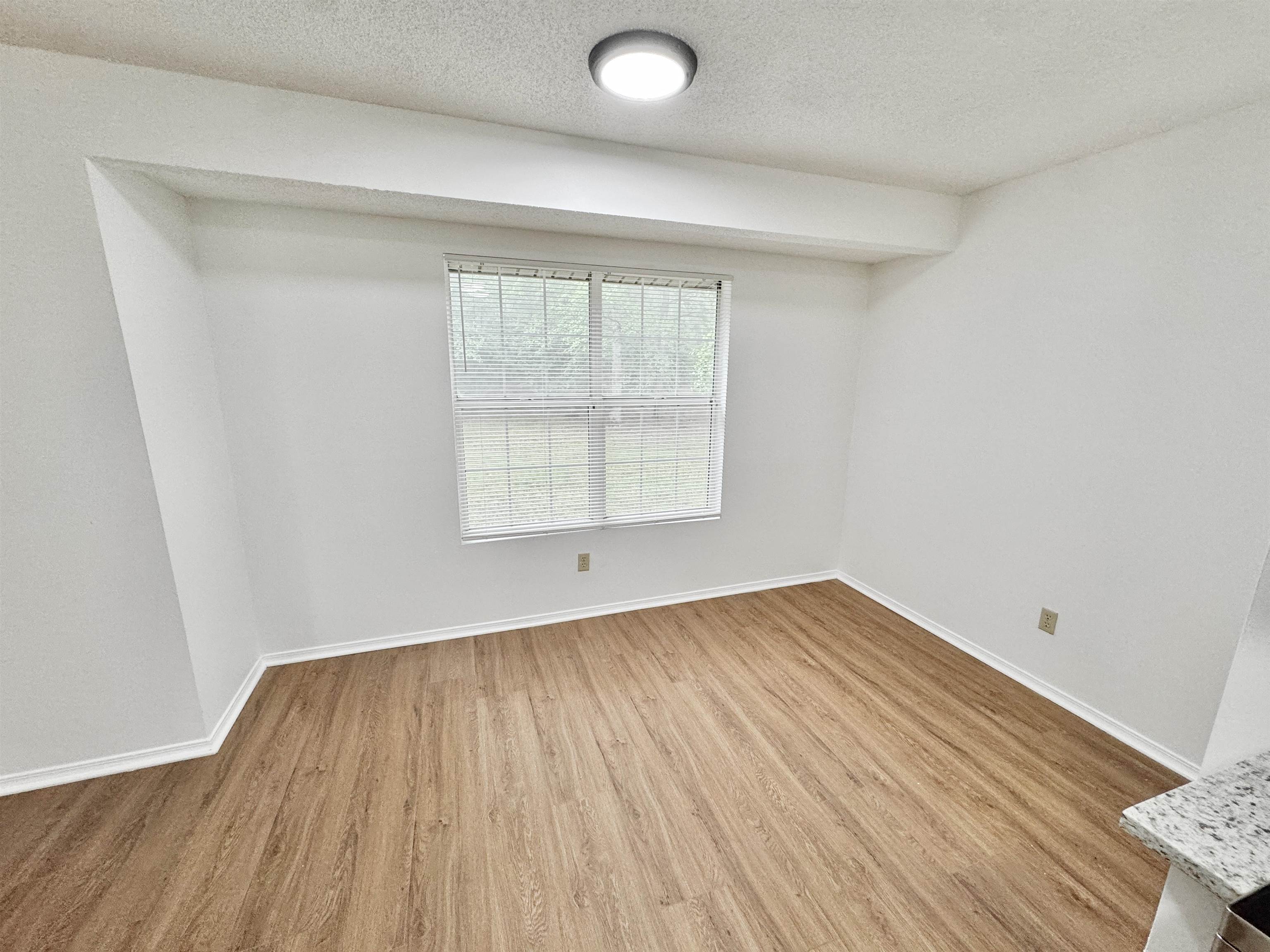 520 Stone Road Pinson, TN 38366 - Photo 8 of 30 Empty room featuring baseboards, wood finished floors, and a textured ceiling