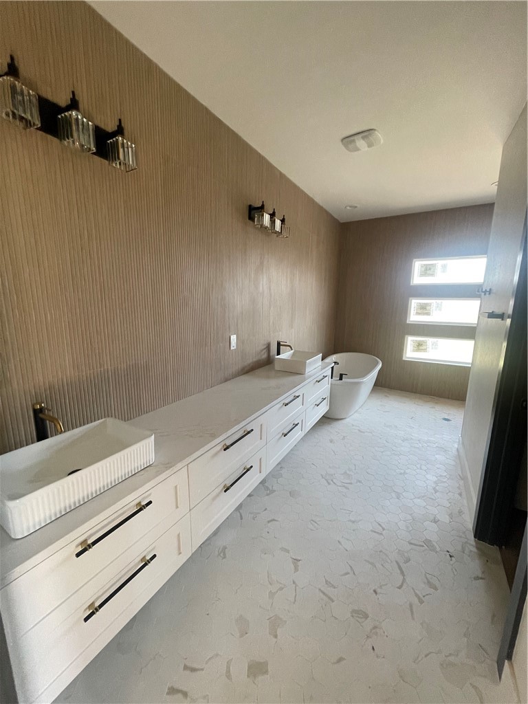 2558 Pacific View Street Corpus Christi, TX 78415 - Photo 12 of 12 a bathroom with a double vanity sink and mirror