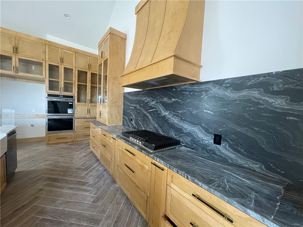 2558 Pacific View Street Corpus Christi, TX 78415 - Photo 8 of 12 a kitchen with granite countertop a stove and a wooden floor