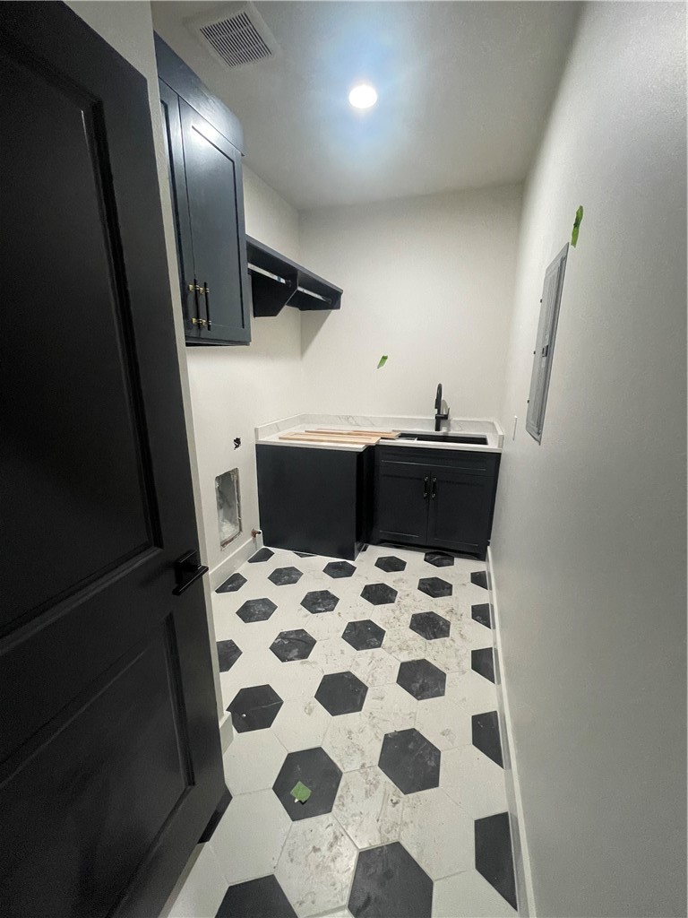 2558 Pacific View Street Corpus Christi, TX 78415 - Photo 9 of 12 a bathroom with a black and white checkered floor