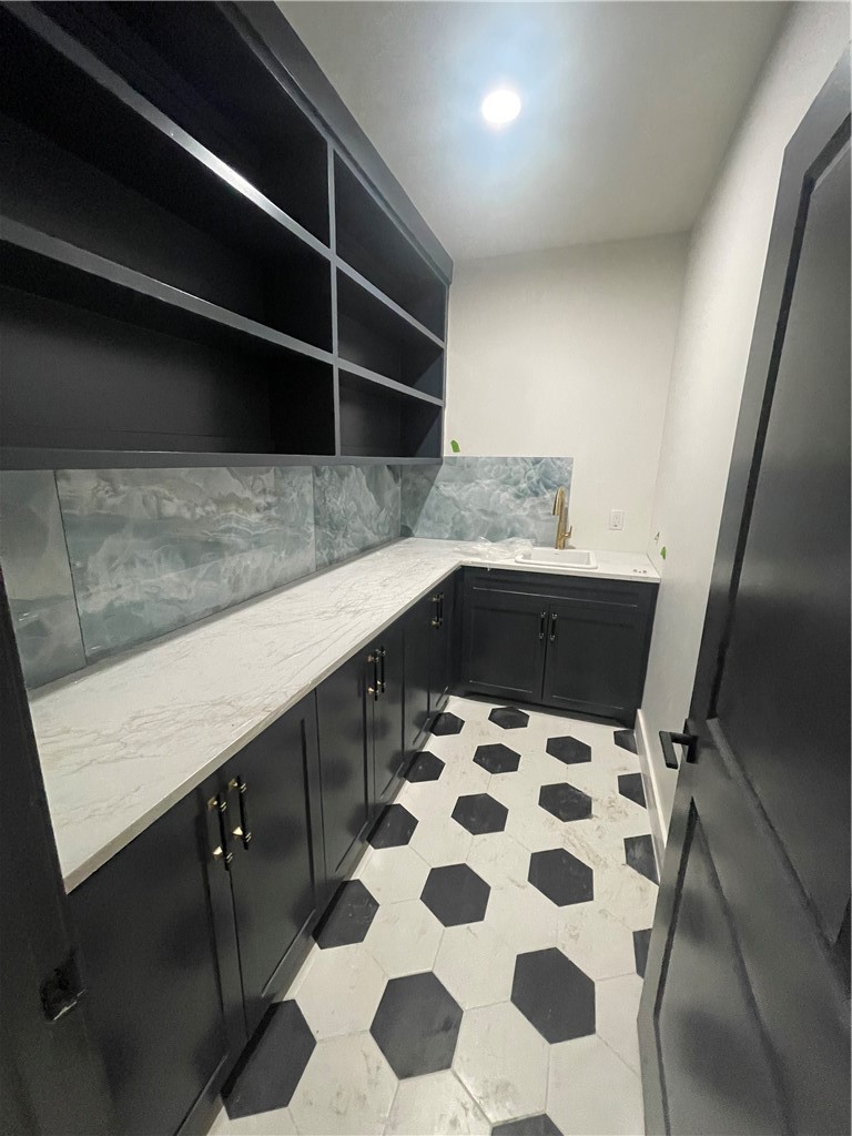 2558 Pacific View Street Corpus Christi, TX 78415 - Photo 10 of 12 a kitchen with a sink a refrigerator and wooden cabinets