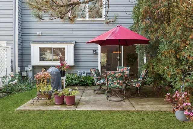 a view of a house with backyard sitting area and garden