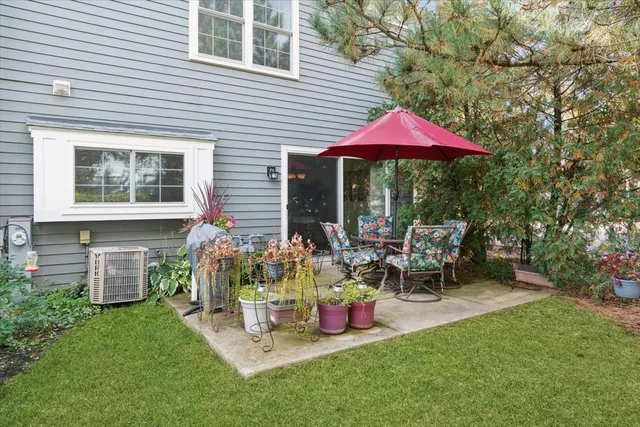 a view of a house with backyard and sitting area