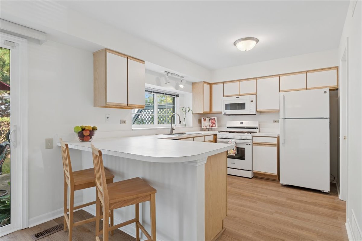 305 Cane Garden Circle, Unit 305 Aurora, IL 60504 - Photo 2 of 20 a kitchen with white cabinets and white appliances