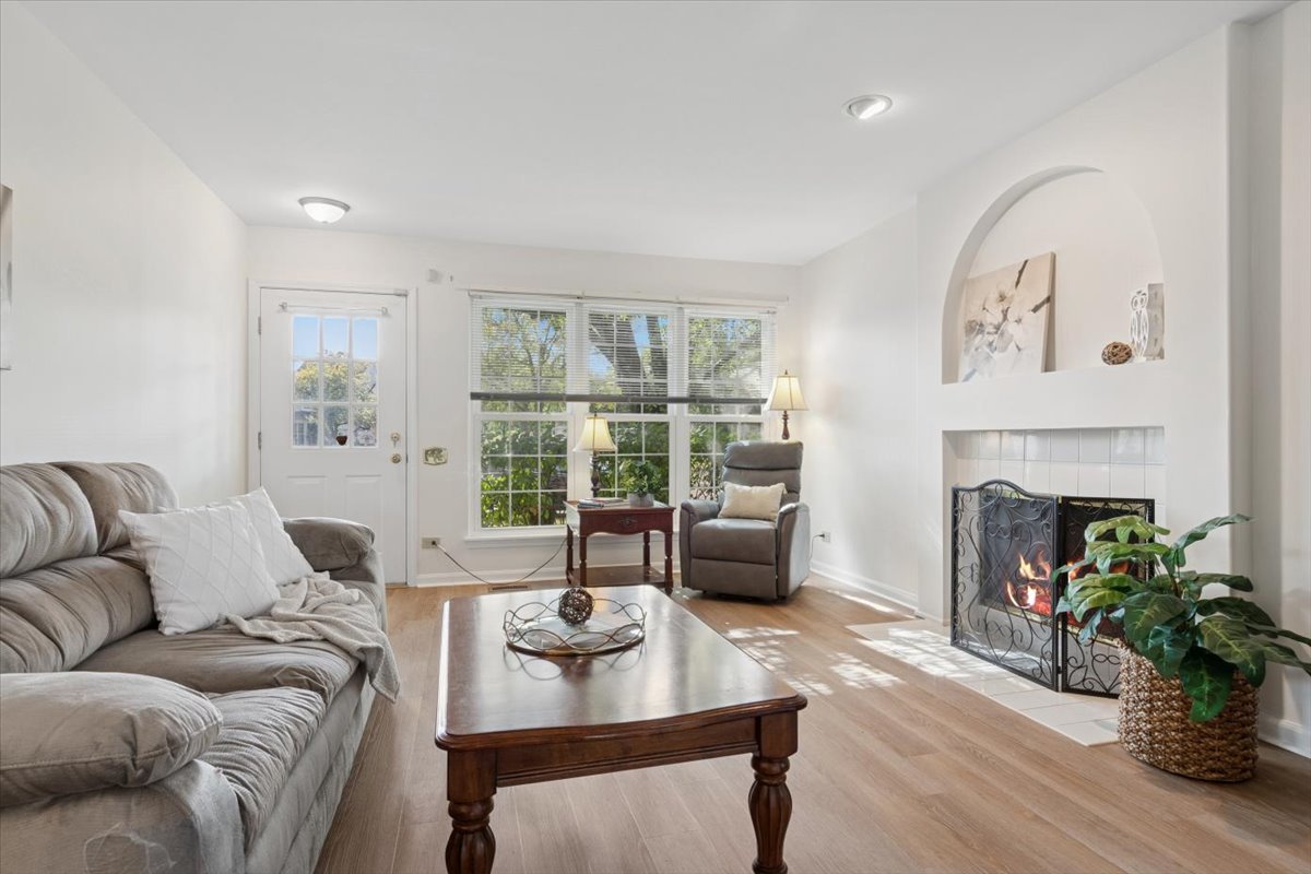 305 Cane Garden Circle, Unit 305 Aurora, IL 60504 - Photo 4 of 20 a living room with furniture a fireplace and a large window