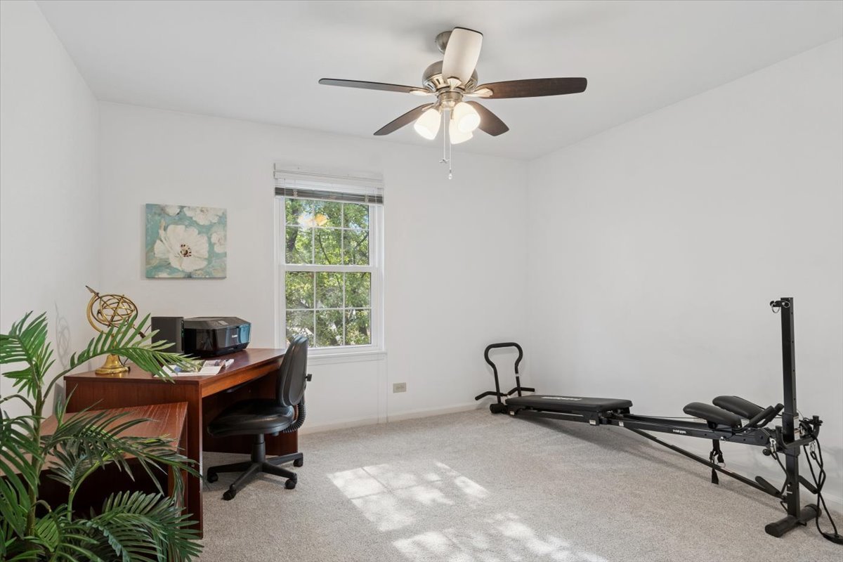 305 Cane Garden Circle, Unit 305 Aurora, IL 60504 - Photo 7 of 20 a room with gym equipment and a window