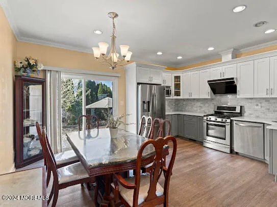 a kitchen with stainless steel appliances a refrigerator sink and microwave