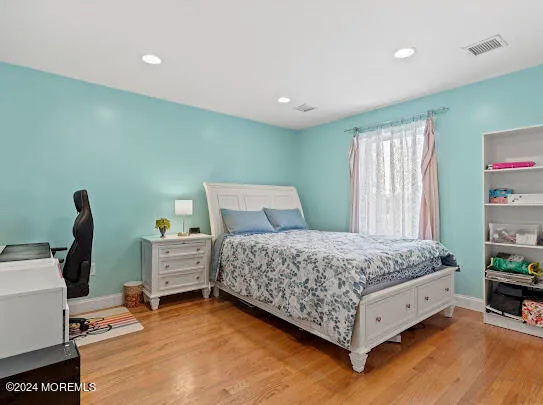 a bedroom with a bed and a chair