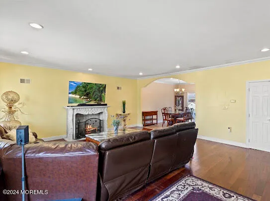 a view of a dining room with furniture a chandelier and wooden floor