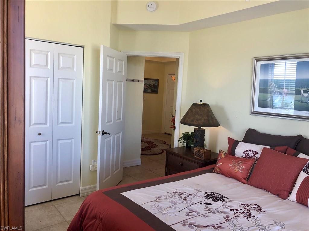 451 Bayfront Place, Unit 5311 Naples, FL 34102 - Photo 35 of 38 a bedroom with a bed and a dresser