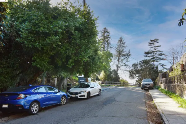 a view of a cars parked on the side of a street