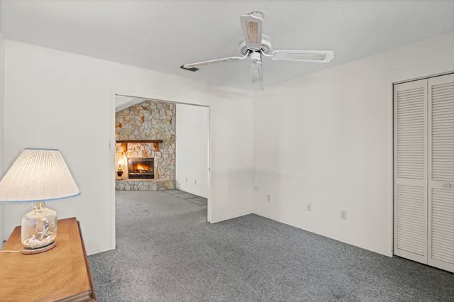 a view of a livingroom with a bed and a lamp