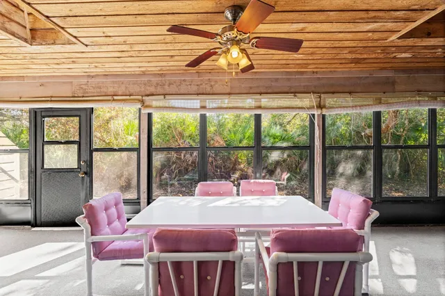 a dining room with a glass top table and chairs