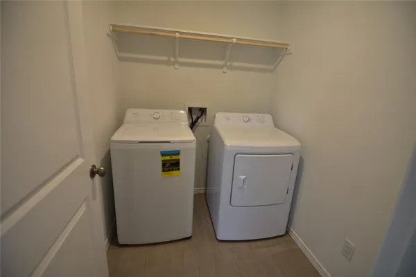 a view of kitchen with refrigerator stove microwave and cabinets