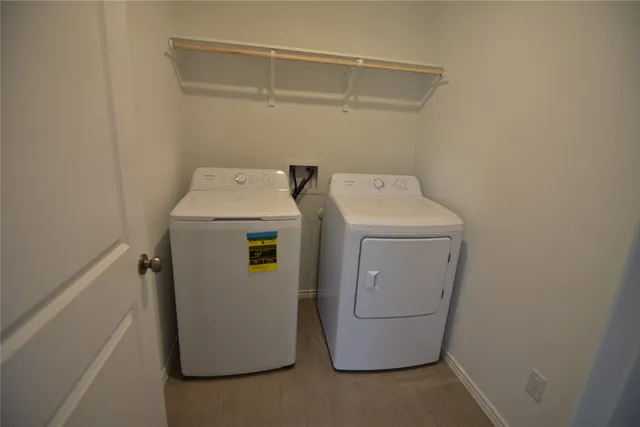a view of kitchen with refrigerator stove microwave and cabinets