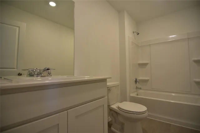 a bathroom with a toilet and a tub