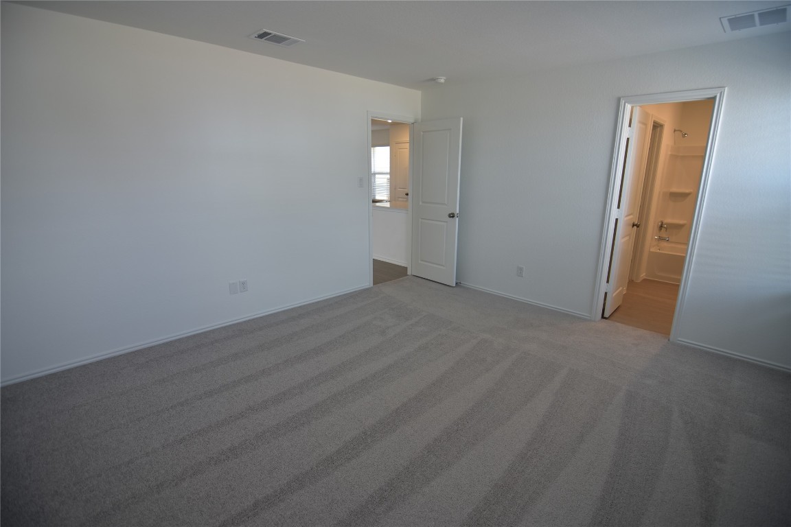 373 Keefer Kyle, TX 78640 - Photo 25 of 39 an empty room with windows and mirror