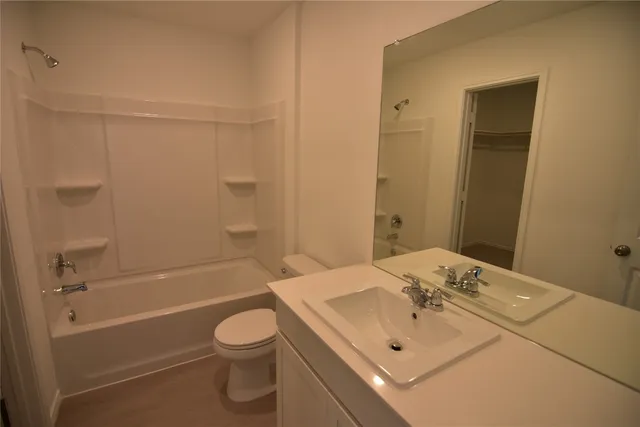 a bathroom with a sink a toilet and bathtub