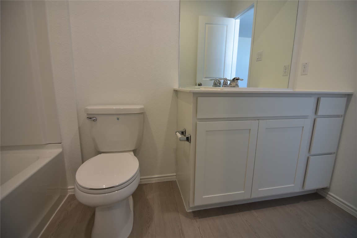 373 Keefer Kyle, TX 78640 - Photo 28 of 39 a bathroom with a toilet a sink a vanity and mirror