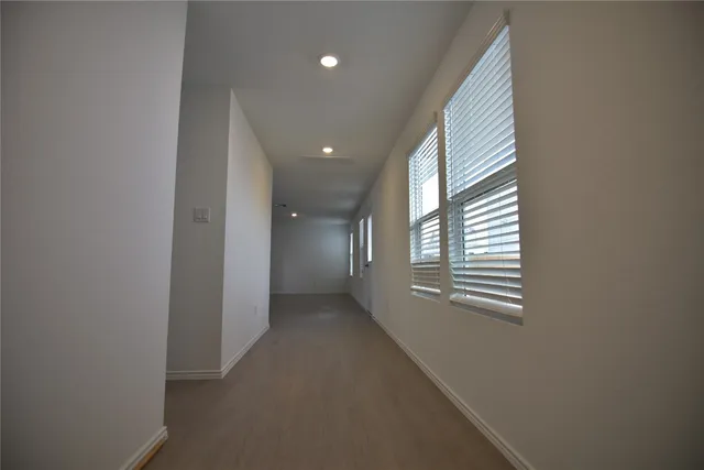 a room with a sink a microwave and window