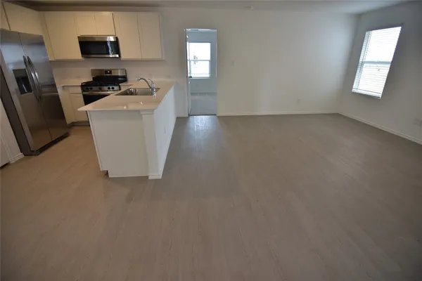 a stove top oven sitting inside of a kitchen