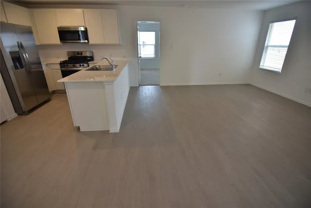 a stove top oven sitting inside of a kitchen