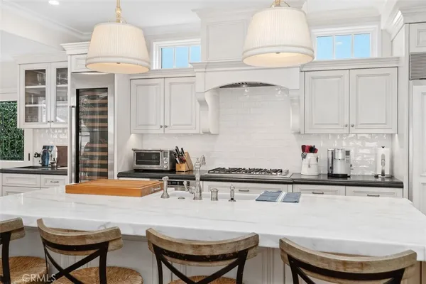a kitchen with stainless steel appliances granite countertop a white cabinets and a sink