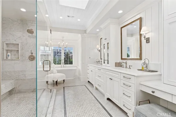 a spacious bathroom with a double vanity sink a mirror and a shower