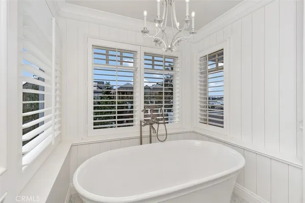 a bathroom with a bathtub and next to a window